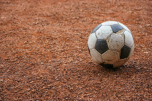 Aged soccer ball on ground