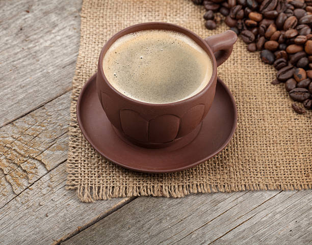 istock Coffee cup and beans on wooden table 501512349