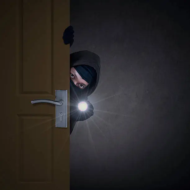Photo of Thief sneaking through door