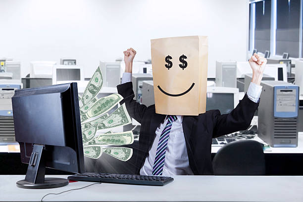 Happ face of businessman looking money Happy businessman looking money coming out from the computer happ stock pictures, royalty-free photos & images