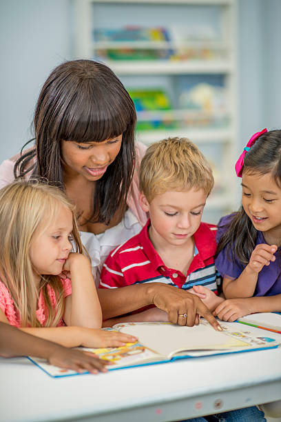 istock Students Looking at Books with Their Teacher 501514718