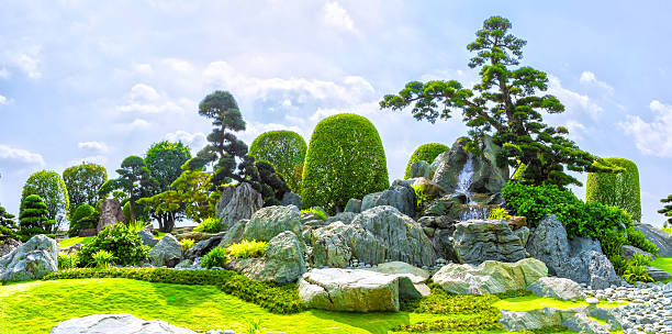Rock garden in Vietnam Ho Chi Minh City, Vietnam - March 3rd, 2014: Bonsai garden beauty with many cypress, pine, stone architecture and ancient trees as paintings incorporate blending in Ho Chi Minh City , Vietnam. chamaecyparis stock pictures, royalty-free photos & images