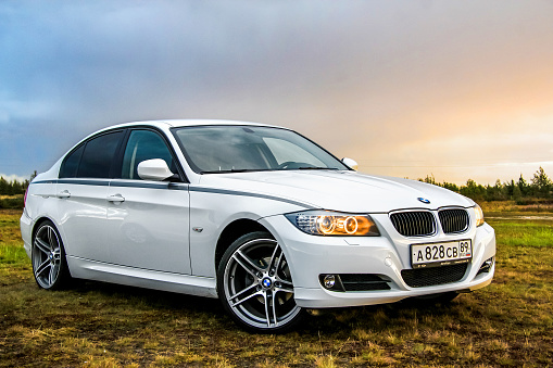 Novyy Urengoy, Russia - August 21, 2015: Motor car BMW E90 318i is parked at the countryside.