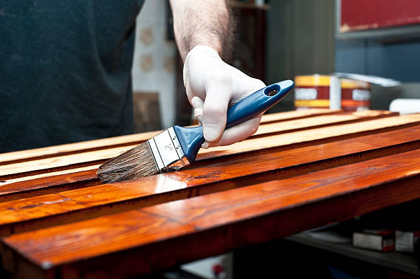 Varnishing wooden boards stock photo