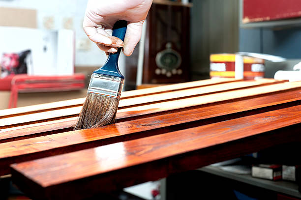 Varnishing wooden boards stock photo