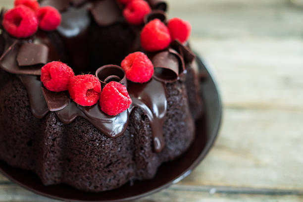 istock Chocolate cake with raspberries on rustic wooden background 501516736