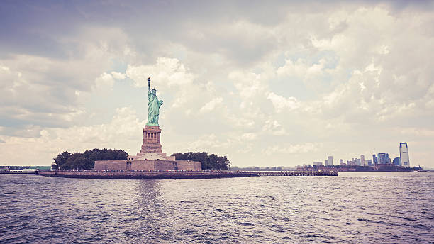 Vintage style Statue of Liberty in cloudy day, New York, USA.