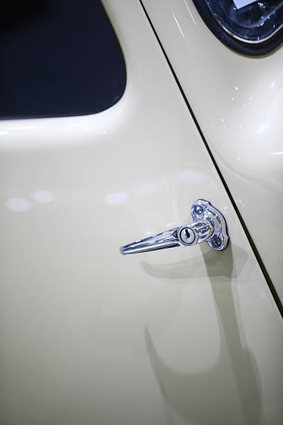 Car door handle Color detail of a white vintage car door handle. door lever stock pictures, royalty-free photos & images