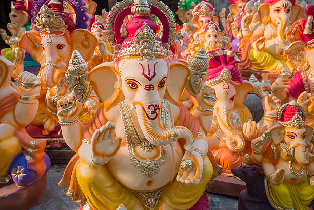 Hindu God Ganesha statues India Elephants statues for Ganesha Chaturthi festival.  The celebration is in honour of the elephant-headed god, Ganesha. It is held on the fourth day of the first fortnight in the month of Bhaadrapada in the Hindu calendar. For around ten days people install temporary shrines with clay statues of the god and group worship him. At the end of the festival, the statues are immersed in bodies of water like lakes, rivers or ponds ganesh chaturthi photos stock pictures, royalty-free photos & images