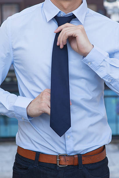 istock Closeup of Male office worker tying a tie 501518120