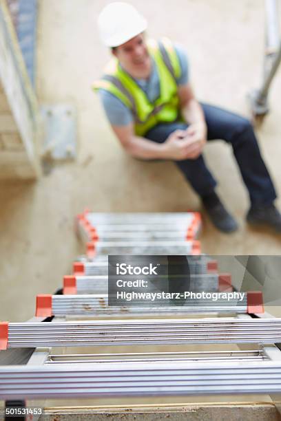 Construction Worker Falling Off Ladder And Injuring Leg Stock Photo - Download Image Now