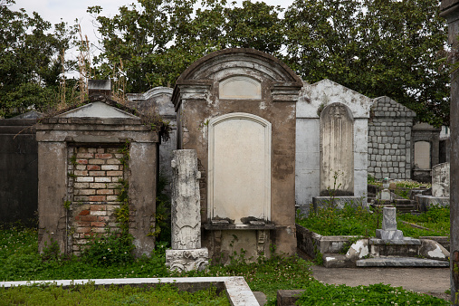 Historic Saint Louis Cemetery in New Orleans.  Above-ground cemeteries are travel destinations in their own right within one of America’s most popular travel destination and tourist cities.  The tombs were wiped of personal information during post processing.  Applicable concepts could include tourism, religion, history, culture, spirituality, or many others.