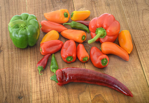 Assortment of peppers on wood stock photo