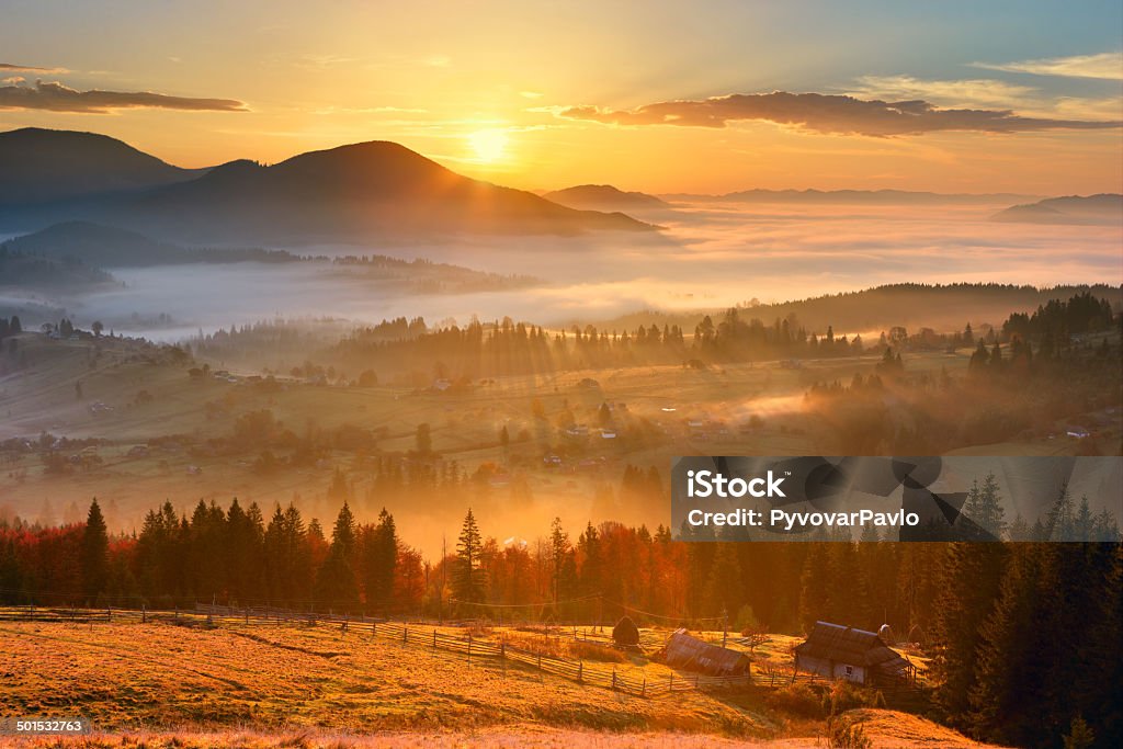 sunrise sunrise, mountain village in the fog and everything nice in yellow light Autumn Stock Photo