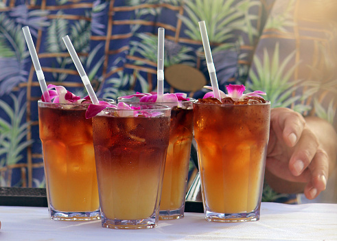 Bartender serving up tropical mai tais in Hawaii.