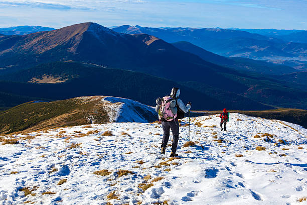 istock Winter Mountain Range View Group Trekkers Walking on SnowTrail 501533262
