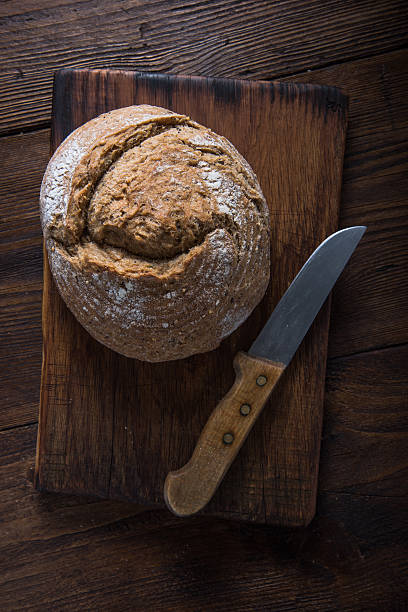istock Homemade bread loaf with vintage knife 501534028
