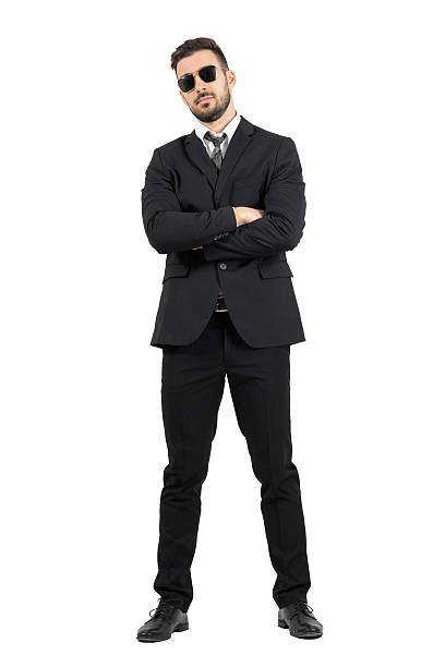 Secret agent or bodyguard with crossed arms looking at camera stock photo
