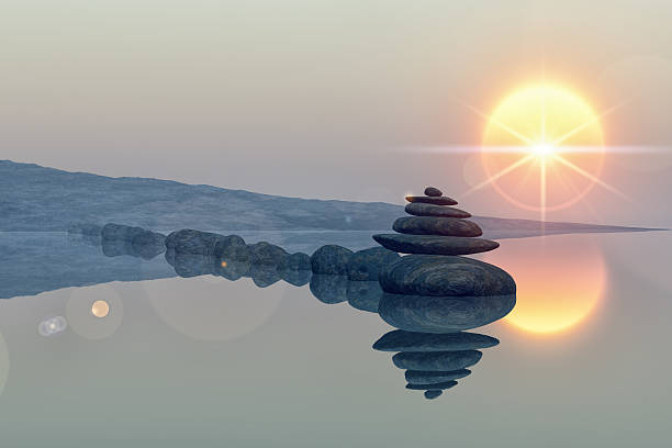 lake with stacked stones calm lake beach with stacked stones, reflections, sun, lens flare star cairn stock pictures, royalty-free photos & images