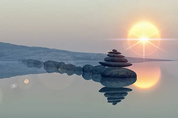 calm lake beach with stacked stones, reflections, sun, lens flare star