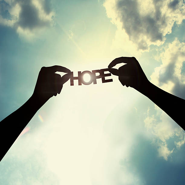 Holding paper cut of hope stock photo