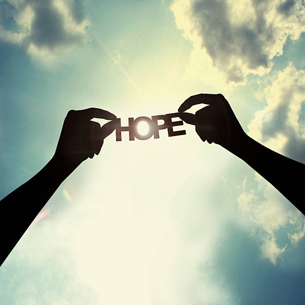 Holding paper cut of hope Show the paper cut word in the sky hope stock pictures, royalty-free photos & images