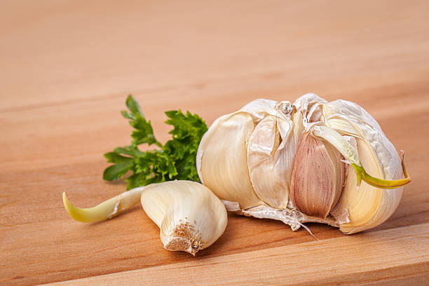 istock Close-up of Garlic with Parsley on a Cutting Board 501536233