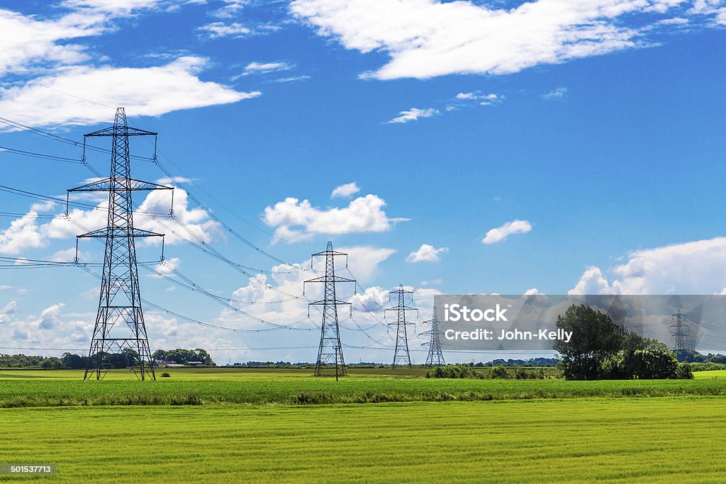 Row of Pylons Row of Pylons in the English countryside Electricity Pylon Stock Photo