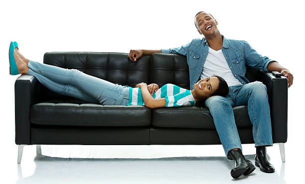 istock Happy couple on couch and looking at camera 501539370