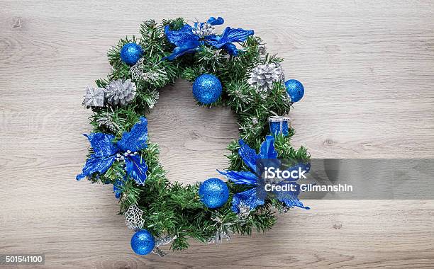 Christmas Blue Wreath On Wood Stock Photo - Download Image Now - 2015, Arrangement, Artificial