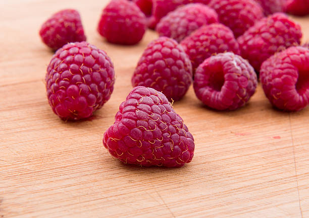 istock Ripe sweet raspberries on wood table close-up 501541446