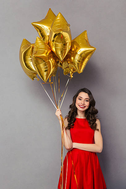 istock Beautiful smiling woman holding balloons 501544140