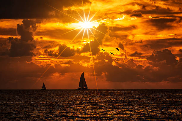 istock Silhouetted boat gainst a vivid colorful sunset 501545706
