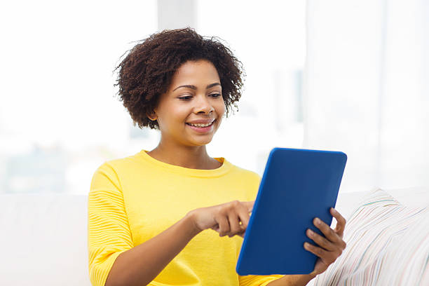 istock happy african american woman with tablet pc 501546778