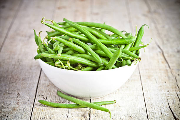 frijoles verdes cuerda en un tazón - green bean fotos fotografías e imágenes de stock