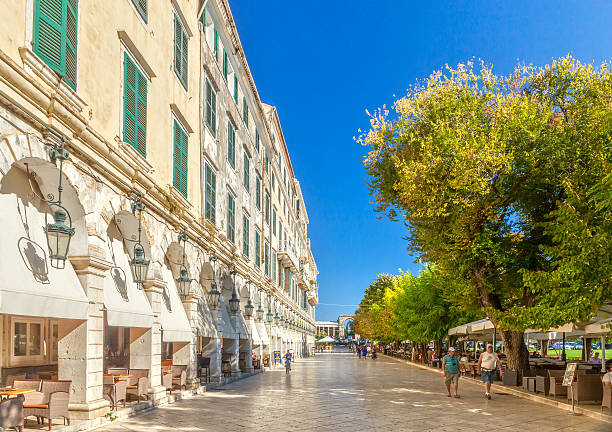 Famous cafes at building at Kapodistriou street Kerkyra, Corfu, Greece - September 24, 2013:: Famous cafes at building at Kapodistriou street with lot of tourists. This street located near platia Enoseos at old city. corfu holiday palace stock pictures, royalty-free photos & images