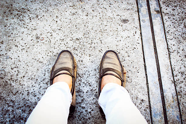 istock Feet on street looking down. 501567122