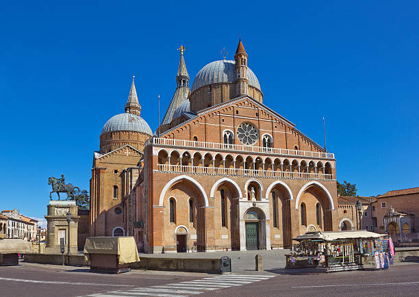 Pontifical Basilica of Saint Anthony of Padua, Italy Pontifical Basilica of Saint Anthony of Padua  (Il Santo) in Padua, Italy with Donatello's equestrian statue of Gattamelata made in 1453 on the left st anthony of padua stock pictures, royalty-free photos & images