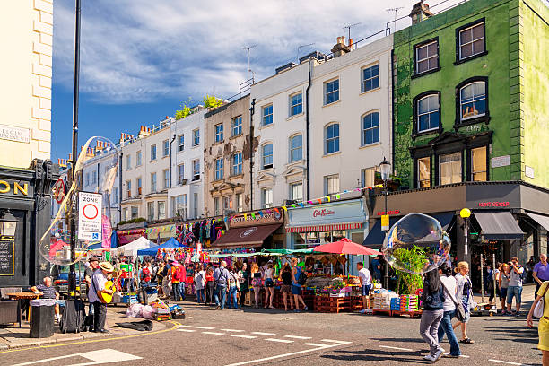 Portobello Road, London London, UK -  August 17, 2012: People in Portobello Road, a famous market area in Notthing Hill. notting hill stock pictures, royalty-free photos & images