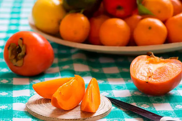 Photo of khaki fruit slices on a table