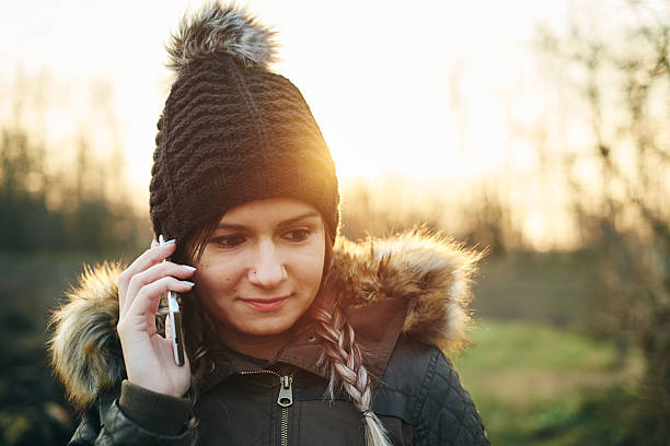 istock Young woman calling with mobile phone outdoors in winter 501571076