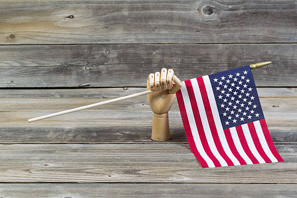 istock Wooden Hand holding American Flag 501571387