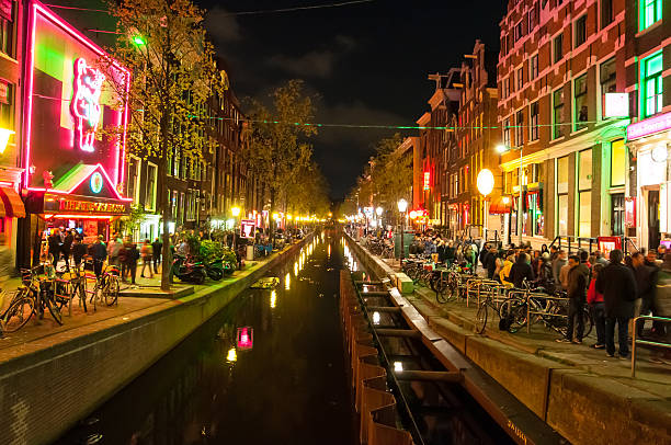 Red light district at night, Casa Rosso on the left. Amsterdam, the Netherlands-May 01,2015:  Red light district (Wallen) at night with famous theatre Casa Rosso on the left hand side, crowd of people on the street. wellen stock pictures, royalty-free photos & images
