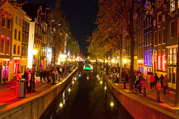 Red light district (Wallen) at night, Amsterdam, the Netherlands. Amsterdam, the Netherlands-May 01,2015: Red light district (Wallen) at night, crowd of people on the street. wellen stock pictures, royalty-free photos & images