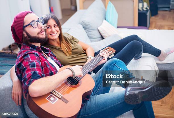 Boyfriend Playing To His Girlfriend Stock Photo - Download Image Now - Affectionate, Armchair, Arts Culture and Entertainment