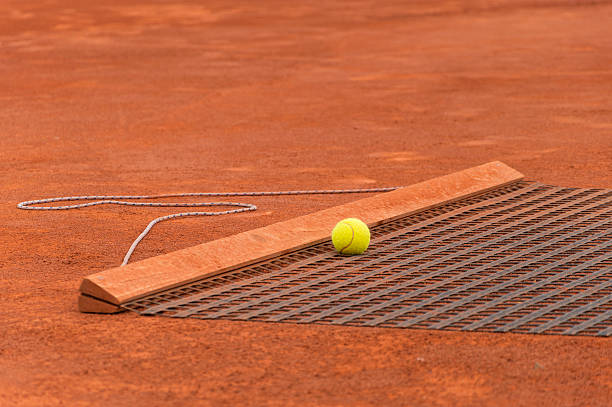 Tennis net Shadow on clay court ground, close-up