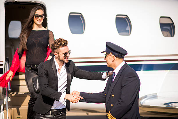 istock Male passenger shaking hands with pilot 501576628