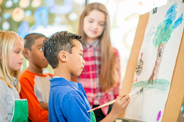 istock Little Boy Painting a Tree 501578124