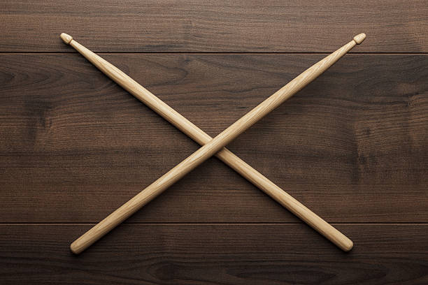 istock crossed wooden drumsticks on wooden table 501579806