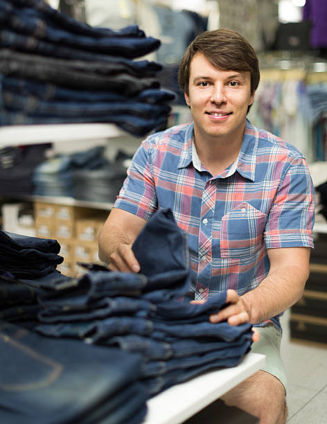 istock male chooses jeans at clothing store 501580532